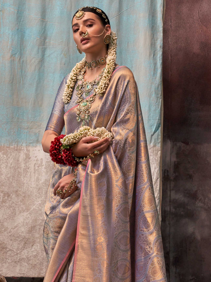 Lavender and Champagne two-tone handwoven silk saree with contrast selvage border and paisley weaving. This image captures the side angle view showcasing blouse styling and zari border detail, ideal for visualizing festive elegance, designer appeal, and modern styling inspiration. Perfect for online shoppers seeking detailed previews before purchase, enhancing saree visual merchandising and SEO-rich product display strategy.