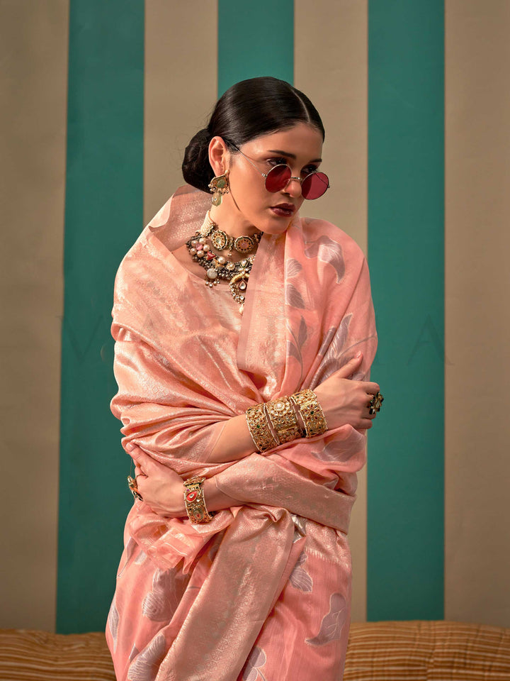 Blush Pink and Silver linen saree with floral woven motifs and soft handloom texture This image captures the model styling perspective with complete saree ensemble displayed, ideal for visualizing festive elegance, designer appeal, and modern styling inspiration. Perfect for online shoppers seeking detailed previews before purchase, enhancing saree visual merchandising and SEO-rich product display strategy.