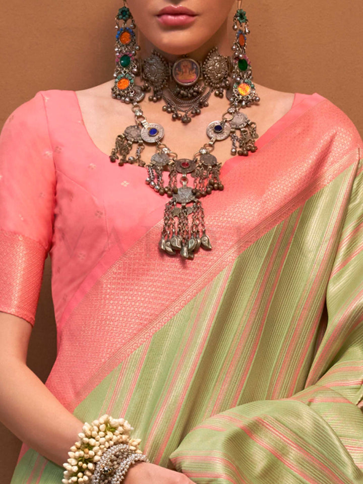 Pista Green and Peach striped silk saree with handloom weave and checked pallu. Ideal for festive season functions like ganesh chaturthi, styled with heritage jewelry and temple-inspired accessories. This image captures the zoomed texture view illustrating fabric weave and print clarity, ideal for visualizing festive elegance, designer appeal, and modern styling inspiration. Perfect for online shoppers seeking detailed previews before purchase, enhancing saree visual merchandising and SEO-rich product displ