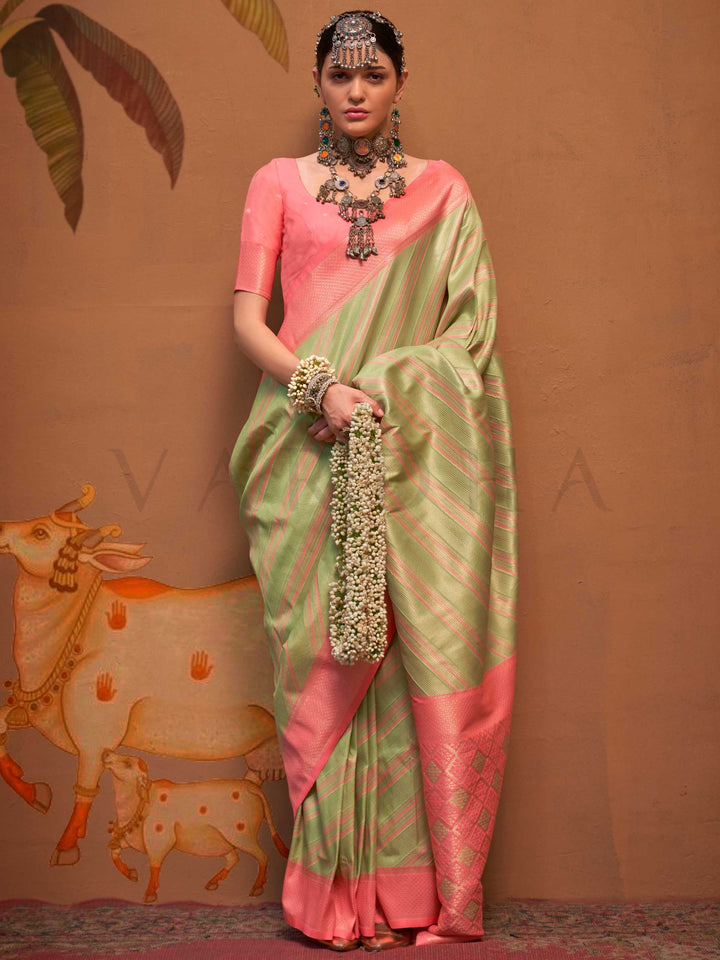 Pista Green and Peach striped silk saree with handloom weave and checked pallu. Ideal for festive season functions like ganesh chaturthi, styled with heritage jewelry and temple-inspired accessories. This image captures the front drape view highlighting pallu fall and pleats alignment, ideal for visualizing festive elegance, designer appeal, and modern styling inspiration. Perfect for online shoppers seeking detailed previews before purchase, enhancing saree visual merchandising and SEO-rich product display