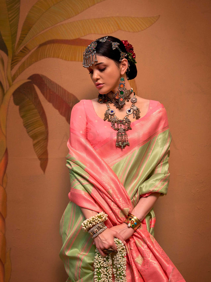 Pista Green and Peach striped silk saree with handloom weave and checked pallu. Ideal for festive season functions like ganesh chaturthi, styled with heritage jewelry and temple-inspired accessories. This image captures the model styling perspective with complete saree ensemble displayed, ideal for visualizing festive elegance, designer appeal, and modern styling inspiration. Perfect for online shoppers seeking detailed previews before purchase, enhancing saree visual merchandising and SEO-rich product disp