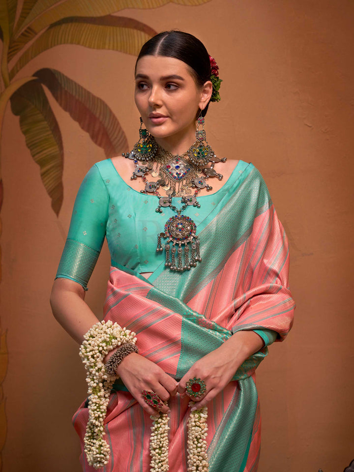 Pink and Sea Green striped silk saree with handloom weave and checked pallu. Ideal for wedding functions like reception look, styled with heritage jewelry and temple-inspired accessories. This image captures the pleats close-up showing symmetry, color blending, and craftsmanship, ideal for visualizing festive elegance, designer appeal, and modern styling inspiration. Perfect for online shoppers seeking detailed previews before purchase, enhancing saree visual merchandising and SEO-rich product display strat