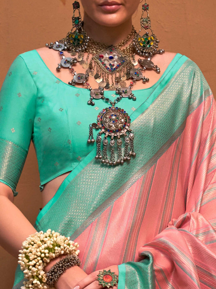Pink and Sea Green striped silk saree with handloom weave and checked pallu. Ideal for wedding functions like reception look, styled with heritage jewelry and temple-inspired accessories. This image captures the zoomed texture view illustrating fabric weave and print clarity, ideal for visualizing festive elegance, designer appeal, and modern styling inspiration. Perfect for online shoppers seeking detailed previews before purchase, enhancing saree visual merchandising and SEO-rich product display strategy.