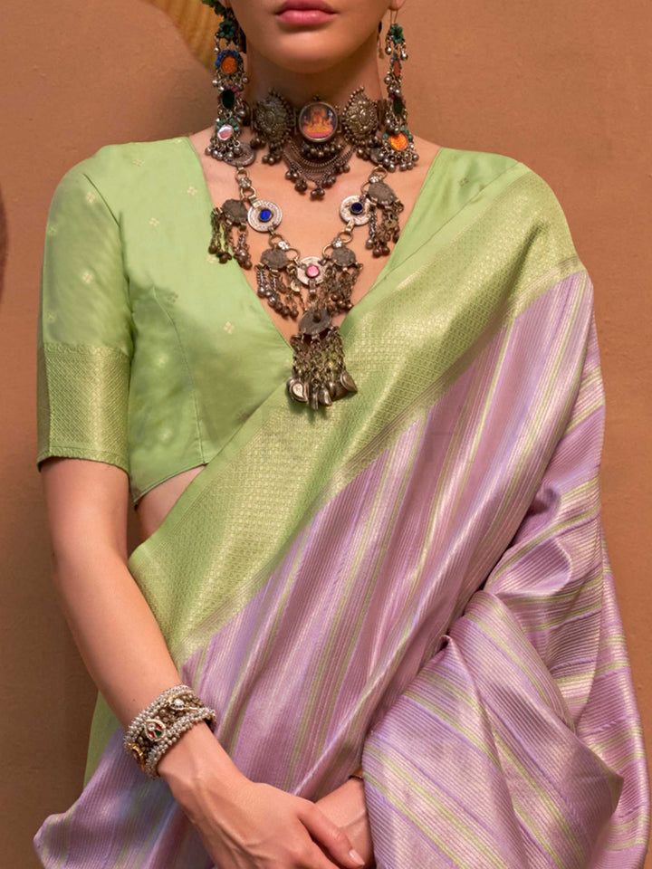 Lavender and Pista Green striped silk saree with handloom weave and checked pallu. Ideal for sangeet functions like sister of bride, styled with heritage jewelry and temple-inspired accessories. This image captures the zoomed texture view illustrating fabric weave and print clarity, ideal for visualizing festive elegance, designer appeal, and modern styling inspiration. Perfect for online shoppers seeking detailed previews before purchase, enhancing saree visual merchandising and SEO-rich product display st