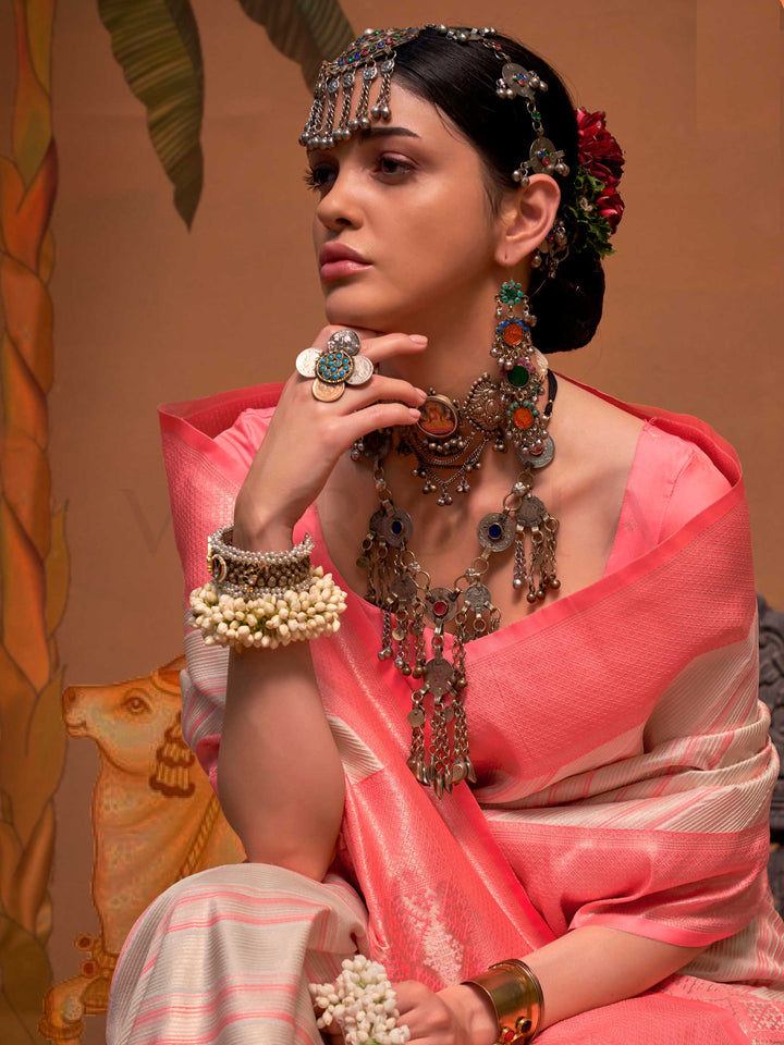 Ivory and Coral Pink striped silk saree with handloom weave and checked pallu. Ideal for wedding functions like bridal day pooja, styled with heritage jewelry and temple-inspired accessories. This image captures the pleats close-up showing symmetry, color blending, and craftsmanship, ideal for visualizing festive elegance, designer appeal, and modern styling inspiration. Perfect for online shoppers seeking detailed previews before purchase, enhancing saree visual merchandising and SEO-rich product display s