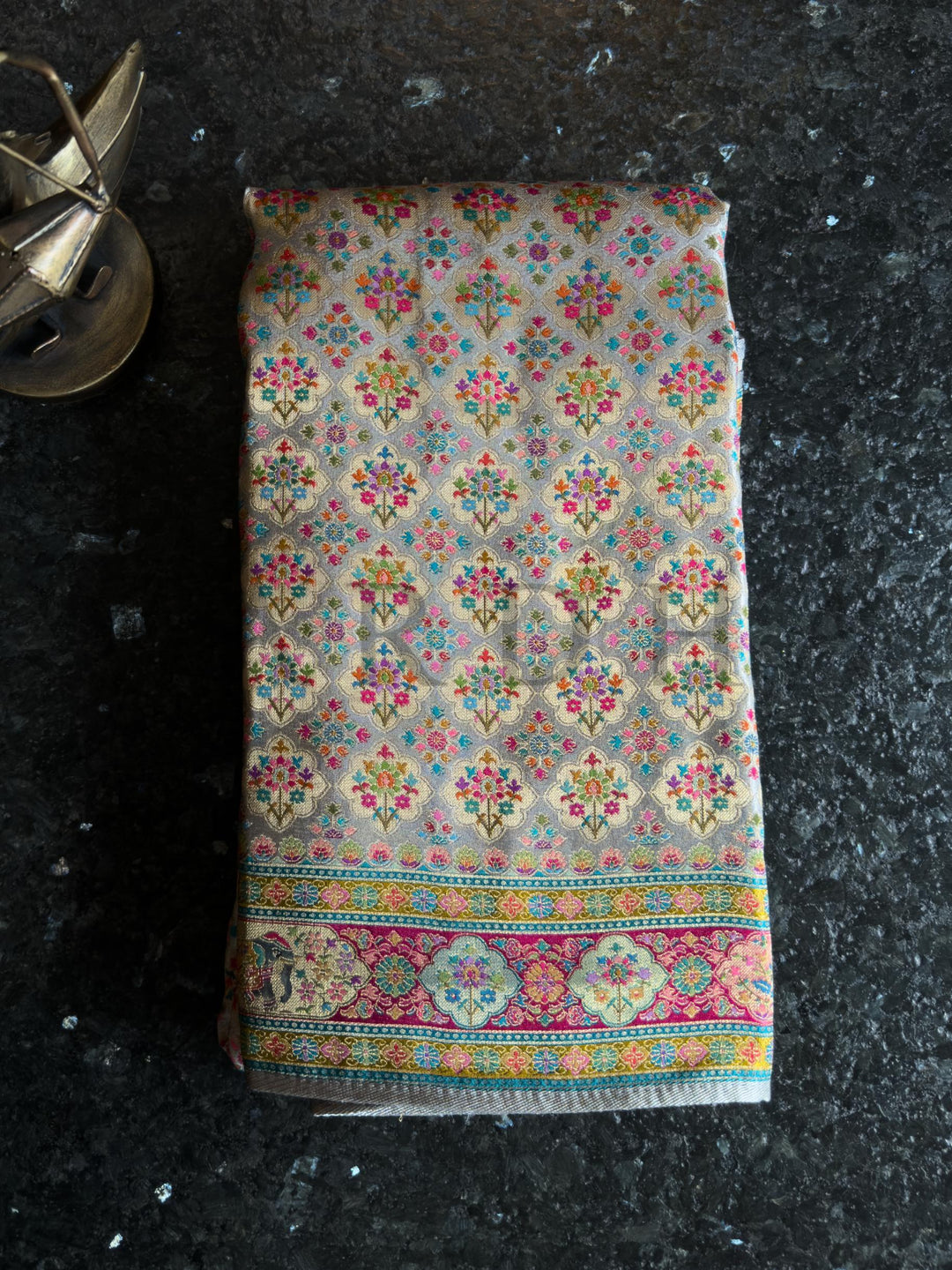 Colorful patterned fabric on a dark surface