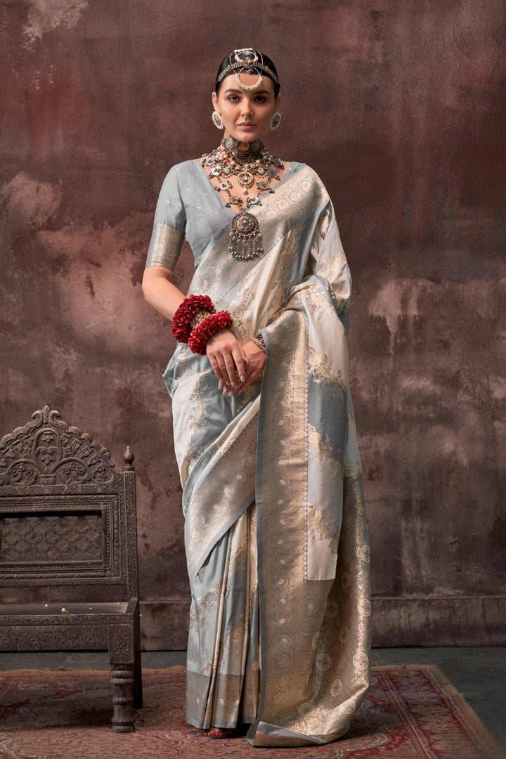 Pearl Grey and Ivory Rangkaat silk saree with temple borders, intricate zari pallu, and traditional wedding styling. Handloom drape perfect for party-wear functions and reception or gala, styled with mogra, antique jewelry, and regal stance. This image captures the front drape view highlighting pallu fall and pleats alignment, ideal for visualizing festive elegance, designer appeal, and modern styling inspiration. Perfect for online shoppers seeking detailed previews before purchase, enhancing saree visual