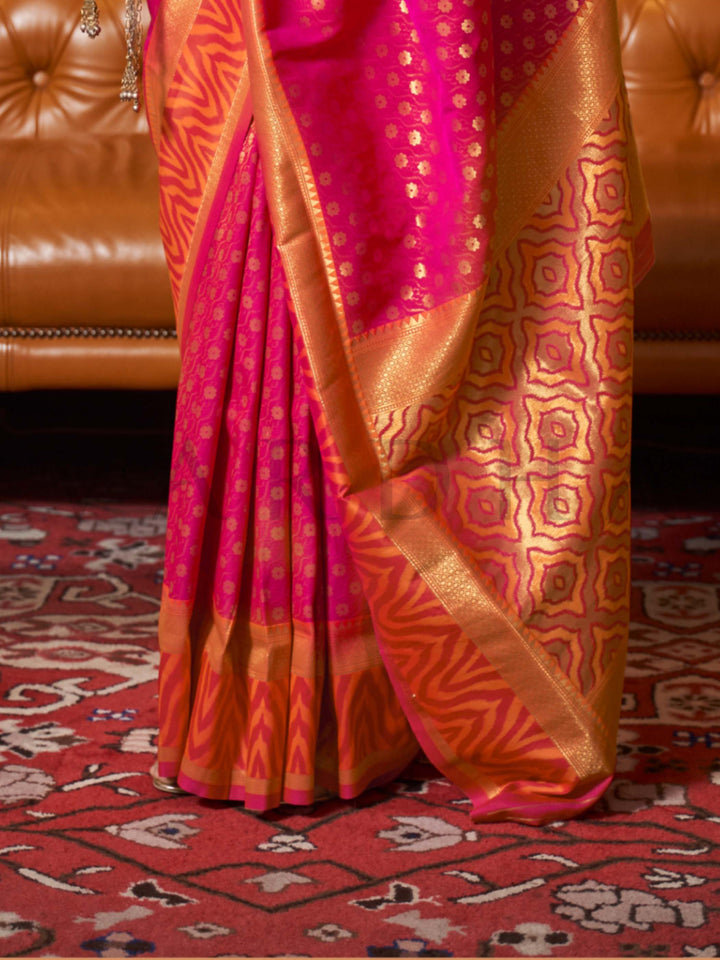 This luxurious Rani Pink–Gold Kanjivaram Silk saree features classic woven zari work with contrast pallu and ornate detailing. Elegant wedding attire with heritage style and timeless drape. SKU 271002. This luxurious Rani Pink–Gold Kanjivaram Silk saree features classic woven zari work with contrast pallu and ornate detailing. Elegant wedding attire with heritage style and timeless drape. SKU 271002.