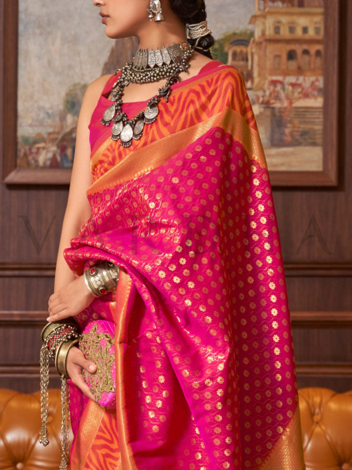 This luxurious Rani Pink–Gold Kanjivaram Silk saree features classic woven zari work with contrast pallu and ornate detailing. Elegant wedding attire with heritage style and timeless drape. SKU 271002. This luxurious Rani Pink–Gold Kanjivaram Silk saree features classic woven zari work with contrast pallu and ornate detailing. Elegant wedding attire with heritage style and timeless drape. SKU 271002.
