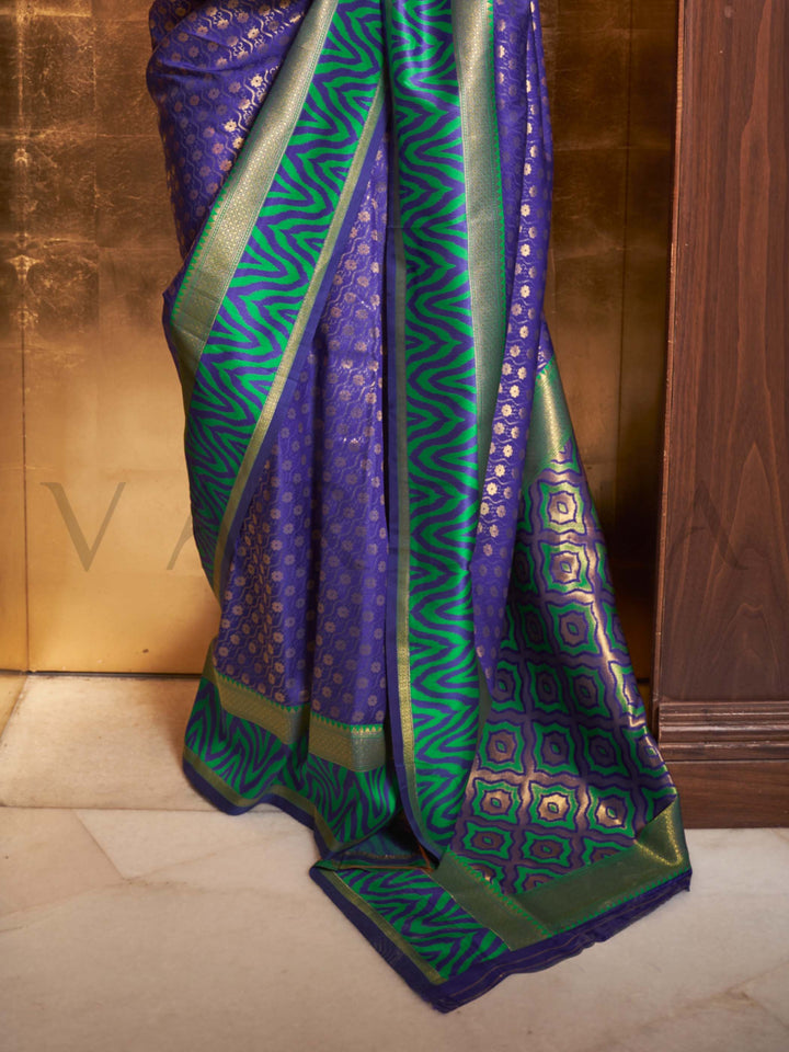 This luxurious Royal Blue–Emerald Green Kanjivaram Silk saree features classic woven zari work with contrast pallu and ornate detailing. Elegant wedding attire with heritage style and timeless drape. SKU 271004. This luxurious Royal Blue–Emerald Green Kanjivaram Silk saree features classic woven zari work with contrast pallu and ornate detailing. Elegant wedding attire with heritage style and timeless drape. SKU 271004.