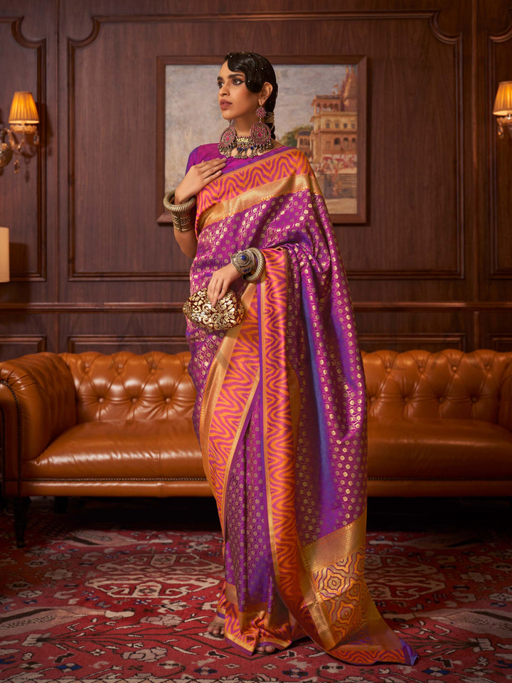 This luxurious Purple–Sunset Orange Kanjivaram Silk saree features classic woven zari work with contrast pallu and ornate detailing. Elegant wedding attire with heritage style and timeless drape. SKU 271005. This luxurious Purple–Sunset Orange Kanjivaram Silk saree features classic woven zari work with contrast pallu and ornate detailing. Elegant wedding attire with heritage style and timeless drape. SKU 271005.