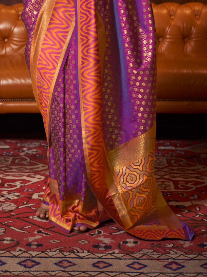 This luxurious Purple–Sunset Orange Kanjivaram Silk saree features classic woven zari work with contrast pallu and ornate detailing. Elegant wedding attire with heritage style and timeless drape. SKU 271005. This luxurious Purple–Sunset Orange Kanjivaram Silk saree features classic woven zari work with contrast pallu and ornate detailing. Elegant wedding attire with heritage style and timeless drape. SKU 271005.