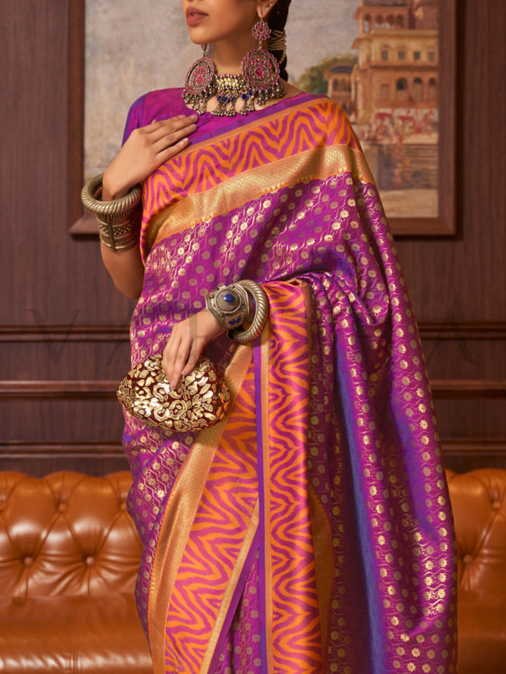 This luxurious Purple–Sunset Orange Kanjivaram Silk saree features classic woven zari work with contrast pallu and ornate detailing. Elegant wedding attire with heritage style and timeless drape. SKU 271005. This luxurious Purple–Sunset Orange Kanjivaram Silk saree features classic woven zari work with contrast pallu and ornate detailing. Elegant wedding attire with heritage style and timeless drape. SKU 271005.