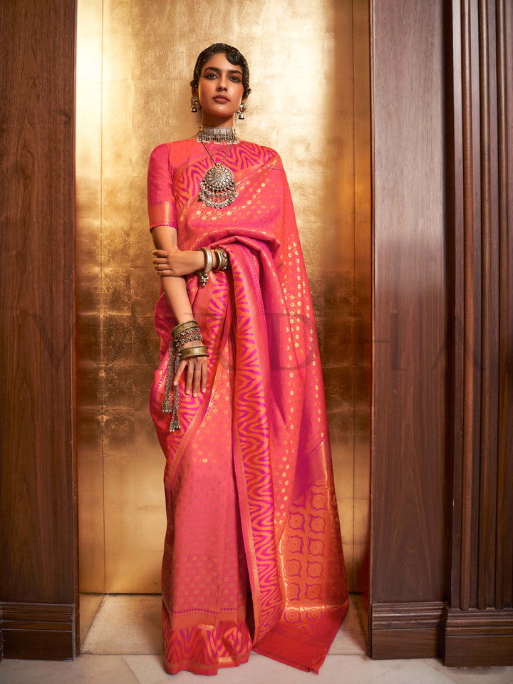 This luxurious Coral Peach–Rose Pink Kanjivaram Silk saree features classic woven zari work with contrast pallu and ornate detailing. Elegant wedding attire with heritage style and timeless drape. SKU 271007. This luxurious Coral Peach–Rose Pink Kanjivaram Silk saree features classic woven zari work with contrast pallu and ornate detailing. Elegant wedding attire with heritage style and timeless drape. SKU 271007.