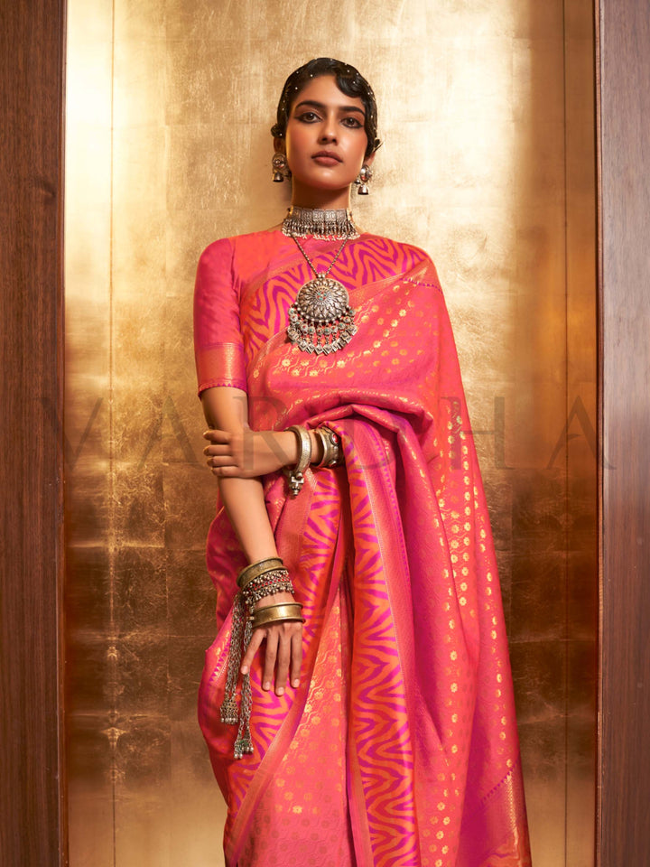 This luxurious Coral Peach–Rose Pink Kanjivaram Silk saree features classic woven zari work with contrast pallu and ornate detailing. Elegant wedding attire with heritage style and timeless drape. SKU 271007. This luxurious Coral Peach–Rose Pink Kanjivaram Silk saree features classic woven zari work with contrast pallu and ornate detailing. Elegant wedding attire with heritage style and timeless drape. SKU 271007.