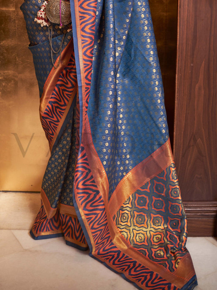 This luxurious Navy Blue–Copper Kanjivaram Silk saree features classic woven zari work with contrast pallu and ornate detailing. Elegant wedding attire with heritage style and timeless drape. SKU 271008. This luxurious Navy Blue–Copper Kanjivaram Silk saree features classic woven zari work with contrast pallu and ornate detailing. Elegant wedding attire with heritage style and timeless drape. SKU 271008.