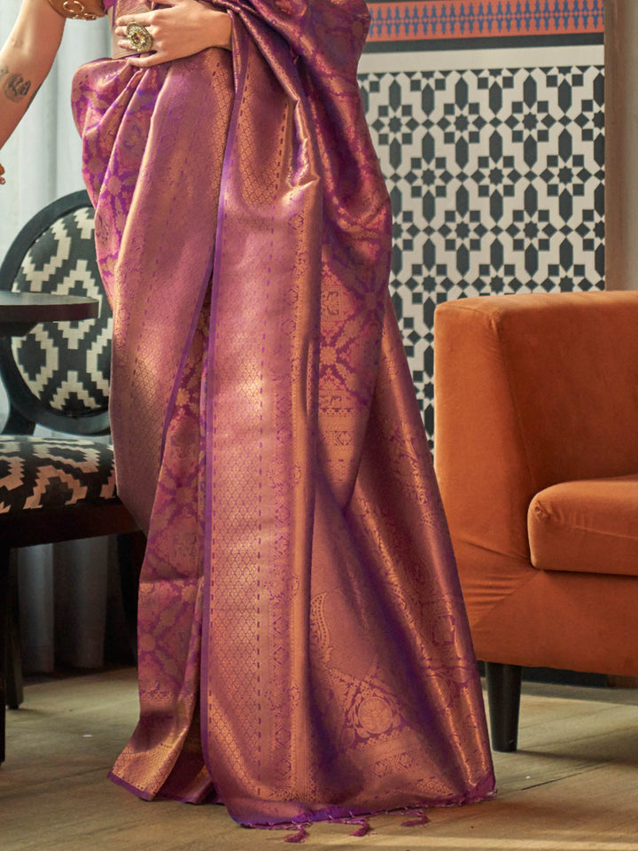 Glossy kanjivaram weave in Purple–Rose Gold with intricate pallu motifs and elegant fall. Classic Purple–Rose Gold bridal saree in silk with woven zari pallu and tassel finish.