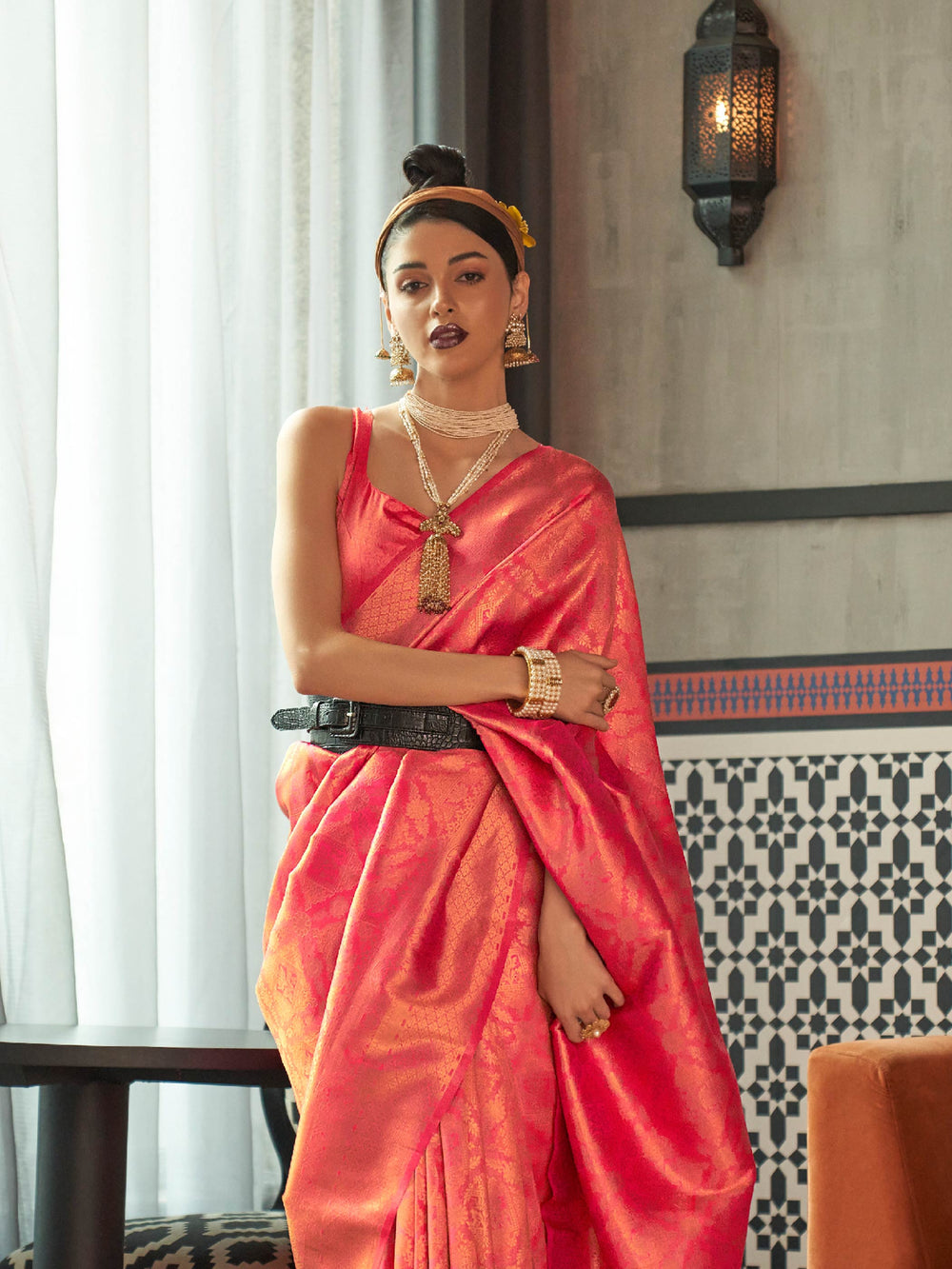 Coral Red–Sunset Orange silk saree featuring temple borders, zari detailing and dual-tone richness. Wedding-ready kanjivaram saree in Coral Red–Sunset Orange styled with regal accessories and clutch.