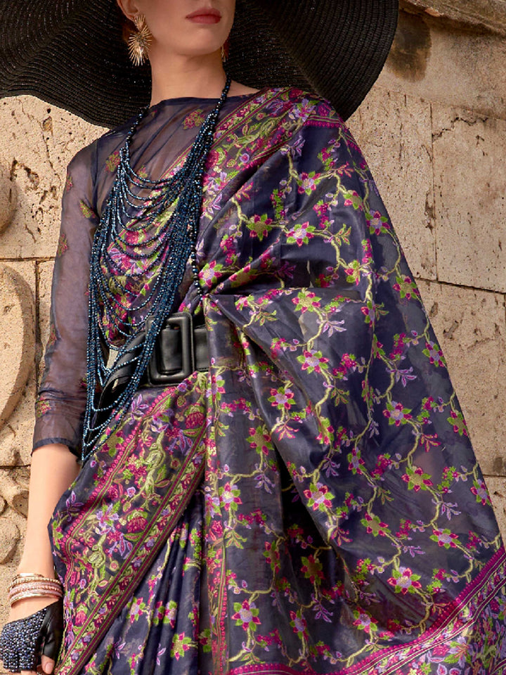 Midnight Navy organza parsi silk saree with intricate multicolor thread floral embroidery and handloom craftsmanship, ideal for bollywood and styled perfectly for premiere night elegance and fashion-forward flair. This image captures the zoomed texture view illustrating fabric weave and print clarity, ideal for visualizing festive elegance, designer appeal, and modern styling inspiration. Perfect for online shoppers seeking detailed previews before purchase, enhancing saree visual merchandising and SEO-rich