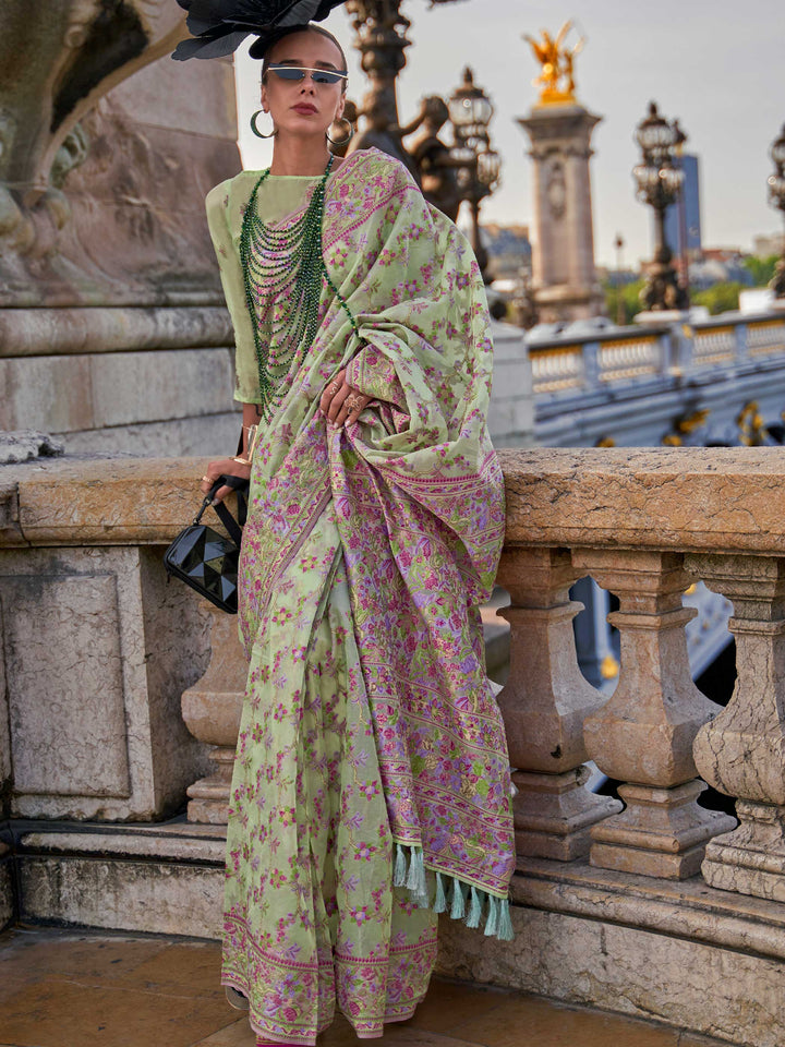 Sage Green organza parsi silk saree with intricate multicolor thread floral embroidery and handloom craftsmanship, ideal for wedding and styled perfectly for daytime varmala elegance and fashion-forward flair. This image captures the front drape view highlighting pallu fall and pleats alignment, ideal for visualizing festive elegance, designer appeal, and modern styling inspiration. Perfect for online shoppers seeking detailed previews before purchase, enhancing saree visual merchandising and SEO-rich produ