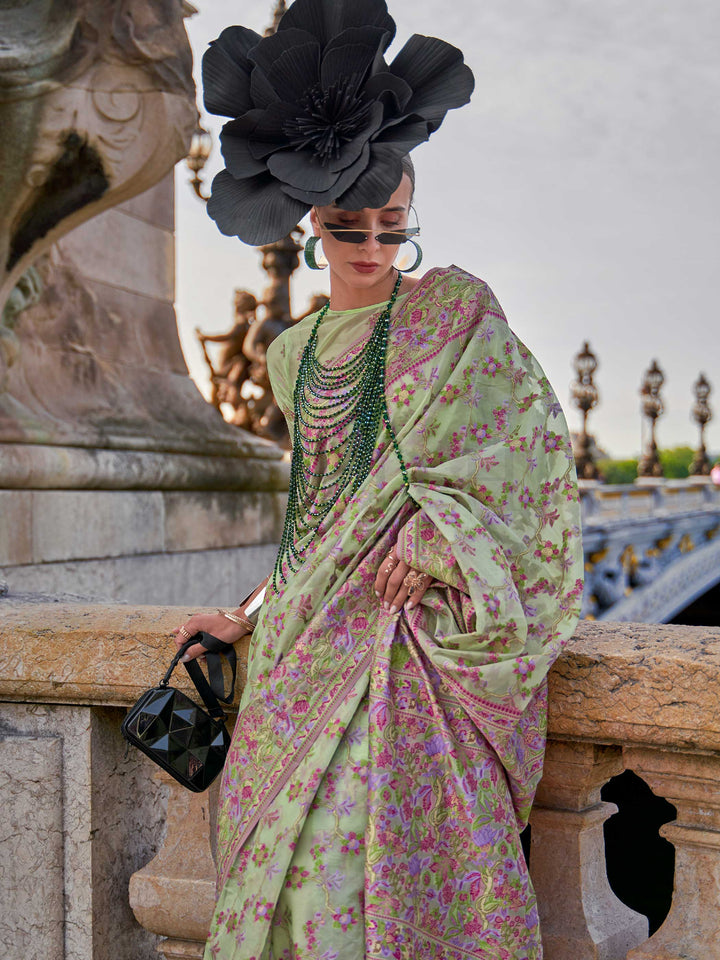 Sage Green organza parsi silk saree with intricate multicolor thread floral embroidery and handloom craftsmanship, ideal for wedding and styled perfectly for daytime varmala elegance and fashion-forward flair. This image captures the model styling perspective with complete saree ensemble displayed, ideal for visualizing festive elegance, designer appeal, and modern styling inspiration. Perfect for online shoppers seeking detailed previews before purchase, enhancing saree visual merchandising and SEO-rich pr