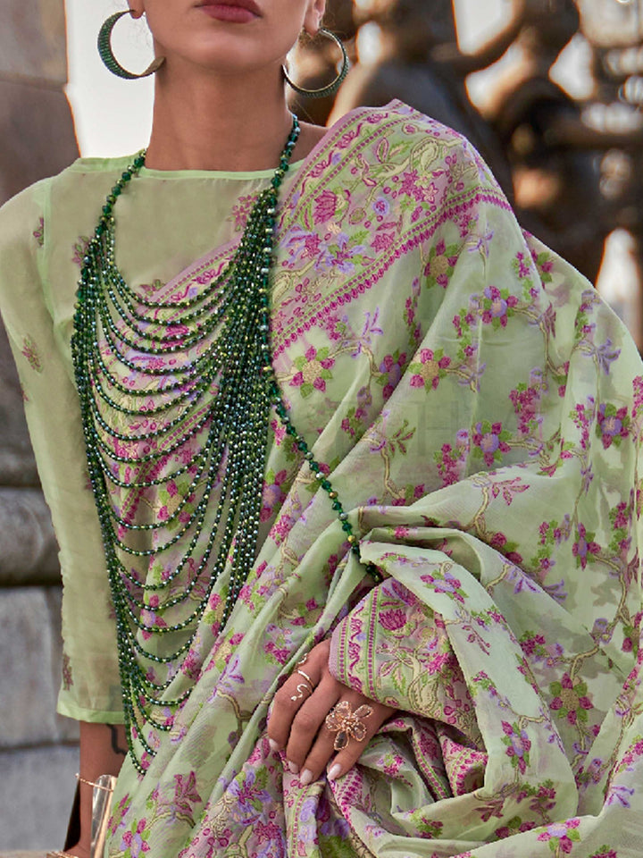 Sage Green organza parsi silk saree with intricate multicolor thread floral embroidery and handloom craftsmanship, ideal for wedding and styled perfectly for daytime varmala elegance and fashion-forward flair. This image captures the zoomed texture view illustrating fabric weave and print clarity, ideal for visualizing festive elegance, designer appeal, and modern styling inspiration. Perfect for online shoppers seeking detailed previews before purchase, enhancing saree visual merchandising and SEO-rich pro