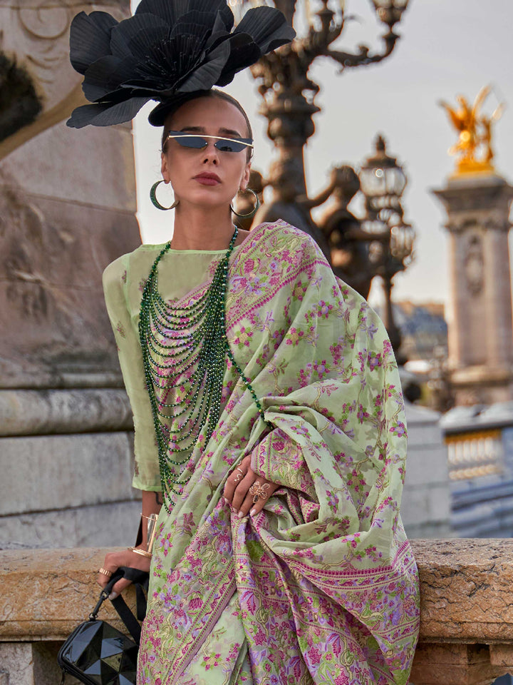 Sage Green organza parsi silk saree with intricate multicolor thread floral embroidery and handloom craftsmanship, ideal for wedding and styled perfectly for daytime varmala elegance and fashion-forward flair. This image captures the side angle view showcasing blouse styling and zari border detail, ideal for visualizing festive elegance, designer appeal, and modern styling inspiration. Perfect for online shoppers seeking detailed previews before purchase, enhancing saree visual merchandising and SEO-rich pr