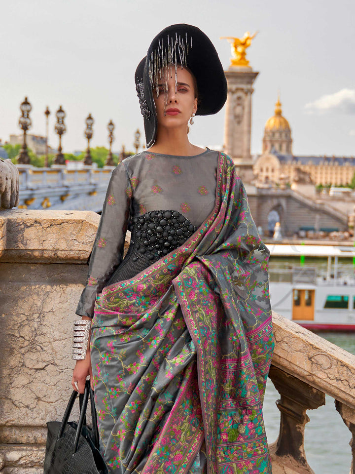 Charcoal Grey organza parsi silk saree with intricate multicolor thread floral embroidery and handloom craftsmanship, ideal for festive season and styled perfectly for diwali celebration elegance and fashion-forward flair. This image captures the side angle view showcasing blouse styling and zari border detail, ideal for visualizing festive elegance, designer appeal, and modern styling inspiration. Perfect for online shoppers seeking detailed previews before purchase, enhancing saree visual merchandising an
