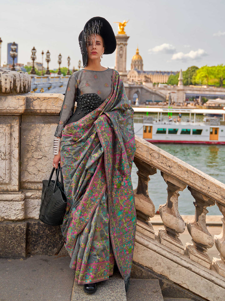 Charcoal Grey organza parsi silk saree with intricate multicolor thread floral embroidery and handloom craftsmanship, ideal for festive season and styled perfectly for diwali celebration elegance and fashion-forward flair. This image captures the front drape view highlighting pallu fall and pleats alignment, ideal for visualizing festive elegance, designer appeal, and modern styling inspiration. Perfect for online shoppers seeking detailed previews before purchase, enhancing saree visual merchandising and S