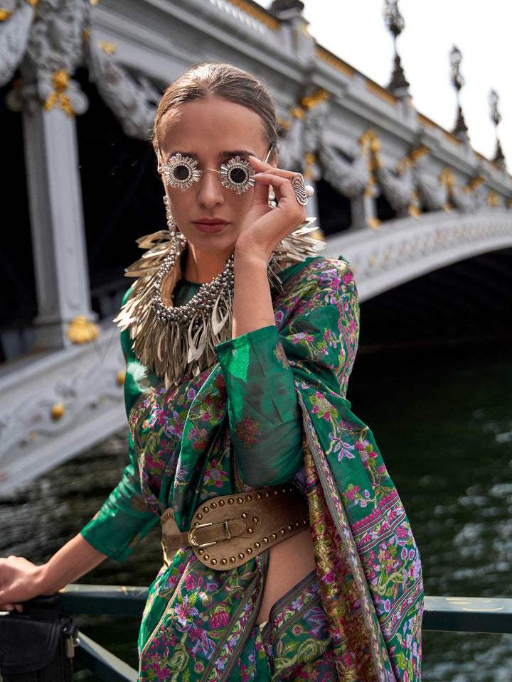 Emerald Green organza parsi silk saree with intricate multicolor thread floral embroidery and handloom craftsmanship, ideal for sangeet and styled perfectly for evening performance elegance and fashion-forward flair. This image captures the model styling perspective with complete saree ensemble displayed, ideal for visualizing festive elegance, designer appeal, and modern styling inspiration. Perfect for online shoppers seeking detailed previews before purchase, enhancing saree visual merchandising and SEO-