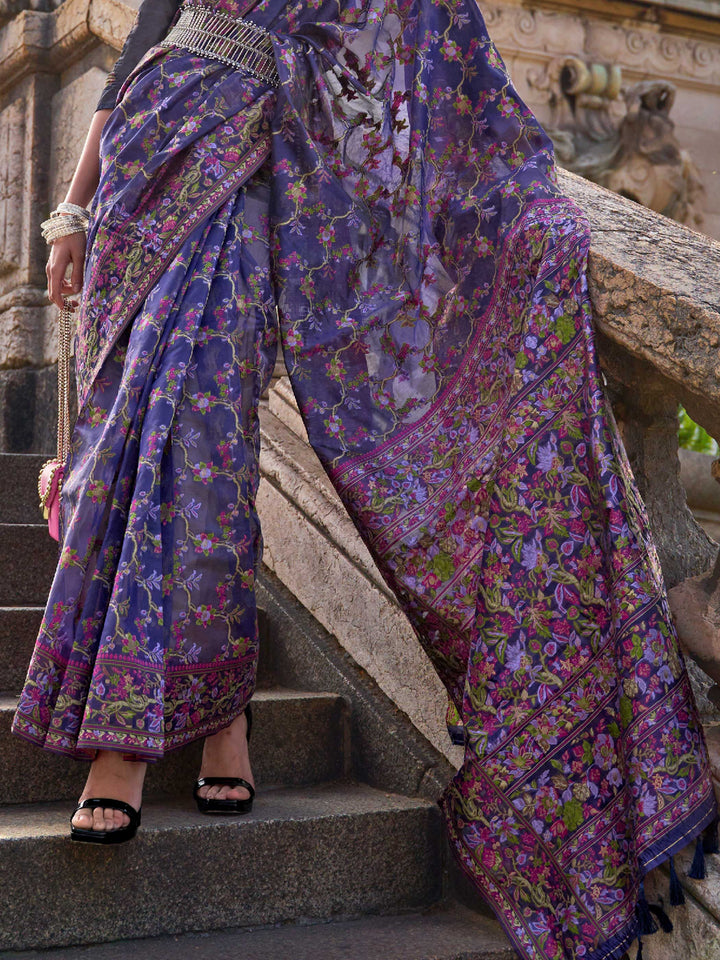 Royal Violet organza parsi silk saree with intricate multicolor thread floral embroidery and handloom craftsmanship, ideal for bollywood and styled perfectly for ramp walk look elegance and fashion-forward flair. This image captures the back drape focus revealing pallu finesse and motif richness, ideal for visualizing festive elegance, designer appeal, and modern styling inspiration. Perfect for online shoppers seeking detailed previews before purchase, enhancing saree visual merchandising and SEO-rich prod