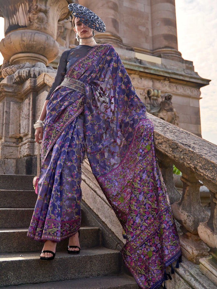 Royal Violet organza parsi silk saree with intricate multicolor thread floral embroidery and handloom craftsmanship, ideal for bollywood and styled perfectly for ramp walk look elegance and fashion-forward flair. This image captures the side angle view showcasing blouse styling and zari border detail, ideal for visualizing festive elegance, designer appeal, and modern styling inspiration. Perfect for online shoppers seeking detailed previews before purchase, enhancing saree visual merchandising and SEO-rich