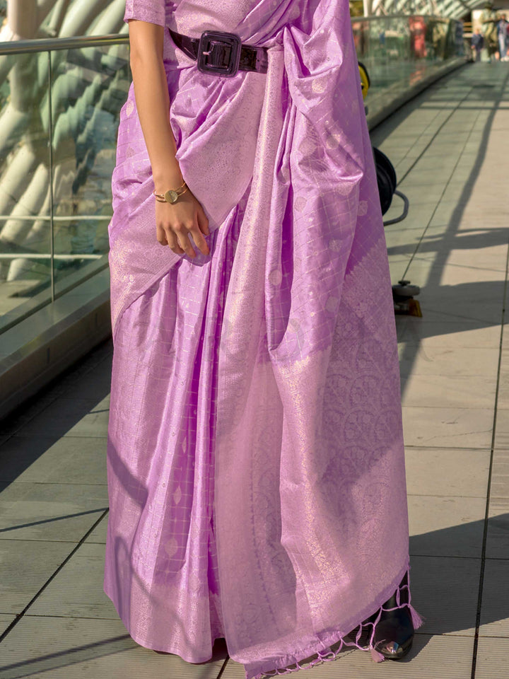 Orchid Mauve Katan silk saree with Ivory Zari zari detailing, featuring checks handloom weaving, designer blouse and tasselled pallu — a perfect fit for sangeet and designer cocktail. Styled with modern belts, hats, and accessories to blend heritage and couture elegance. This image captures the back drape focus revealing pallu finesse and motif richness, ideal for visualizing festive elegance, designer appeal, and modern styling inspiration. Perfect for online shoppers seeking detailed previews before purch