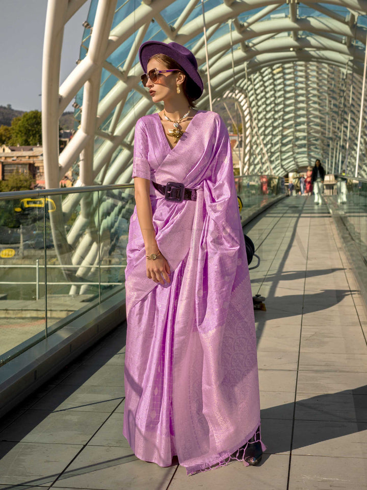 Orchid Mauve Katan silk saree with Ivory Zari zari detailing, featuring checks handloom weaving, designer blouse and tasselled pallu — a perfect fit for sangeet and designer cocktail. Styled with modern belts, hats, and accessories to blend heritage and couture elegance. This image captures the front drape view highlighting pallu fall and pleats alignment, ideal for visualizing festive elegance, designer appeal, and modern styling inspiration. Perfect for online shoppers seeking detailed previews before pur
