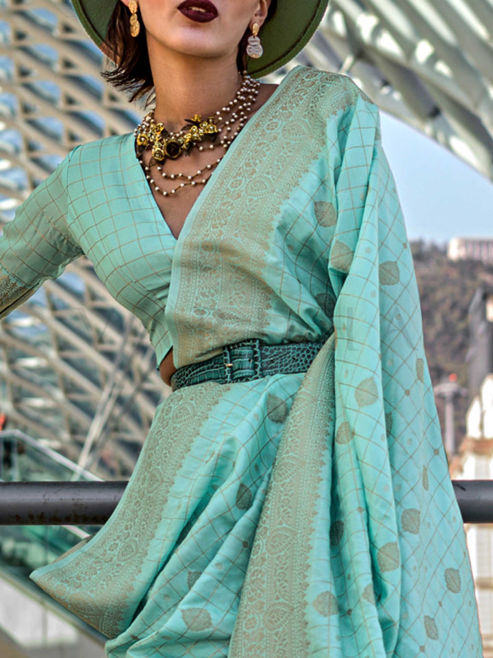 Seafoam Green Katan silk saree with Cool Beige zari detailing, featuring checks handloom weaving, designer blouse and tasselled pallu — a perfect fit for festive season and day pooja & diwali. Styled with modern belts, hats, and accessories to blend heritage and couture elegance. This image captures the zoomed texture view illustrating fabric weave and print clarity, ideal for visualizing festive elegance, designer appeal, and modern styling inspiration. Perfect for online shoppers seeking detailed previews