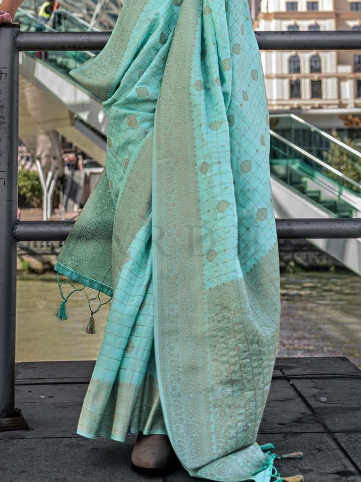 Seafoam Green Katan silk saree with Cool Beige zari detailing, featuring checks handloom weaving, designer blouse and tasselled pallu — a perfect fit for festive season and day pooja & diwali. Styled with modern belts, hats, and accessories to blend heritage and couture elegance. This image captures the back drape focus revealing pallu finesse and motif richness, ideal for visualizing festive elegance, designer appeal, and modern styling inspiration. Perfect for online shoppers seeking detailed previews bef