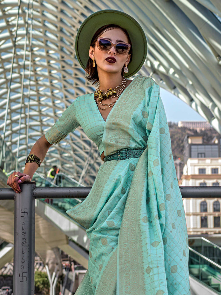 Seafoam Green Katan silk saree with Cool Beige zari detailing, featuring checks handloom weaving, designer blouse and tasselled pallu — a perfect fit for festive season and day pooja & diwali. Styled with modern belts, hats, and accessories to blend heritage and couture elegance. This image captures the side angle view showcasing blouse styling and zari border detail, ideal for visualizing festive elegance, designer appeal, and modern styling inspiration. Perfect for online shoppers seeking detailed preview