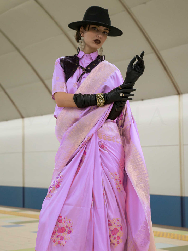 Lavender Lilac silk saree with Rose Gold zari and Pink Fuchsia floral motifs, styled with contrast blouse, handloom weaving, festive-ready look with cinematic silhouette and bold accessories — ideal for events and grand celebrations. This image captures the side angle view showcasing blouse styling and zari border detail, ideal for visualizing festive elegance, designer appeal, and modern styling inspiration. Perfect for online shoppers seeking detailed previews before purchase, enhancing saree visual merch