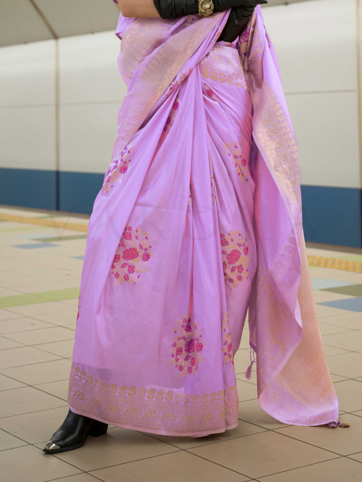 Lavender Lilac silk saree with Rose Gold zari and Pink Fuchsia floral motifs, styled with contrast blouse, handloom weaving, festive-ready look with cinematic silhouette and bold accessories — ideal for events and grand celebrations. This image captures the back drape focus revealing pallu finesse and motif richness, ideal for visualizing festive elegance, designer appeal, and modern styling inspiration. Perfect for online shoppers seeking detailed previews before purchase, enhancing saree visual merchandis