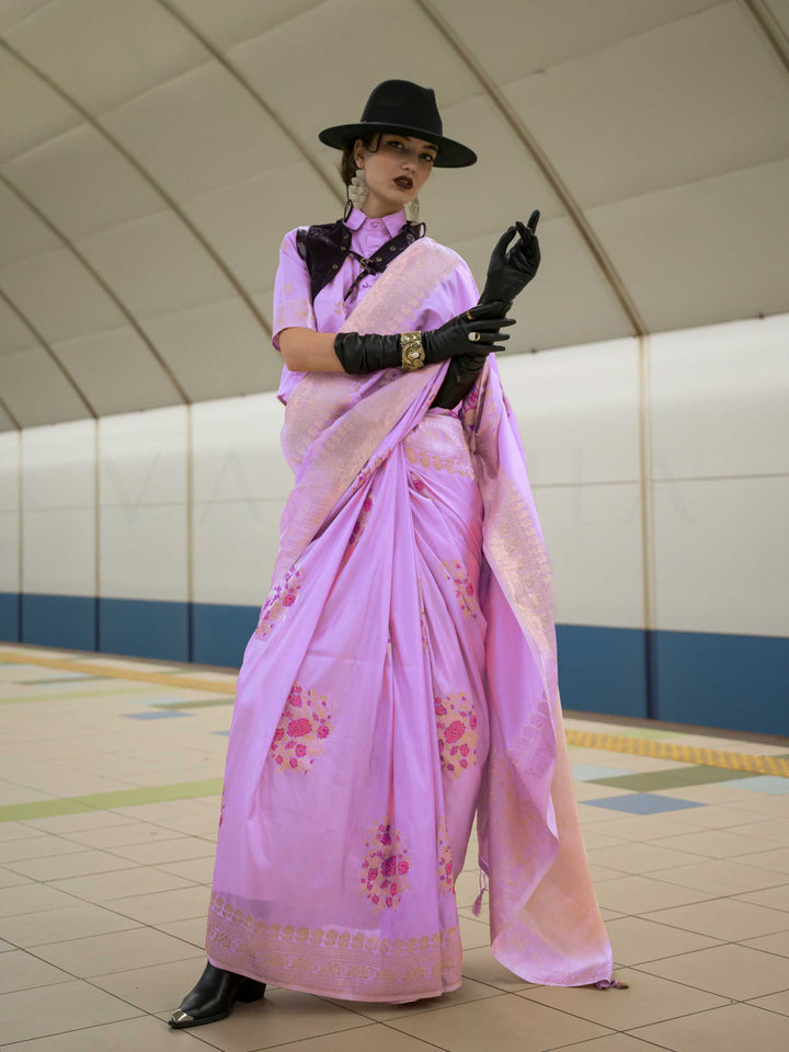 Lavender Lilac silk saree with Rose Gold zari and Pink Fuchsia floral motifs, styled with contrast blouse, handloom weaving, festive-ready look with cinematic silhouette and bold accessories — ideal for events and grand celebrations. This image captures the front drape view highlighting pallu fall and pleats alignment, ideal for visualizing festive elegance, designer appeal, and modern styling inspiration. Perfect for online shoppers seeking detailed previews before purchase, enhancing saree visual merchand