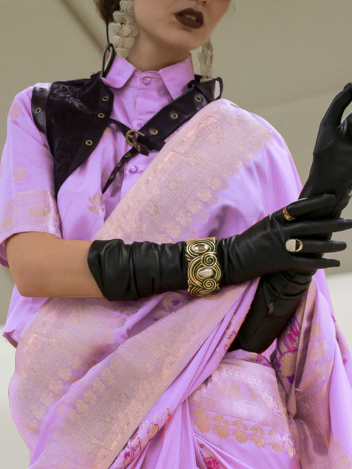Lavender Lilac silk saree with Rose Gold zari and Pink Fuchsia floral motifs, styled with contrast blouse, handloom weaving, festive-ready look with cinematic silhouette and bold accessories — ideal for events and grand celebrations. This image captures the zoomed texture view illustrating fabric weave and print clarity, ideal for visualizing festive elegance, designer appeal, and modern styling inspiration. Perfect for online shoppers seeking detailed previews before purchase, enhancing saree visual mercha