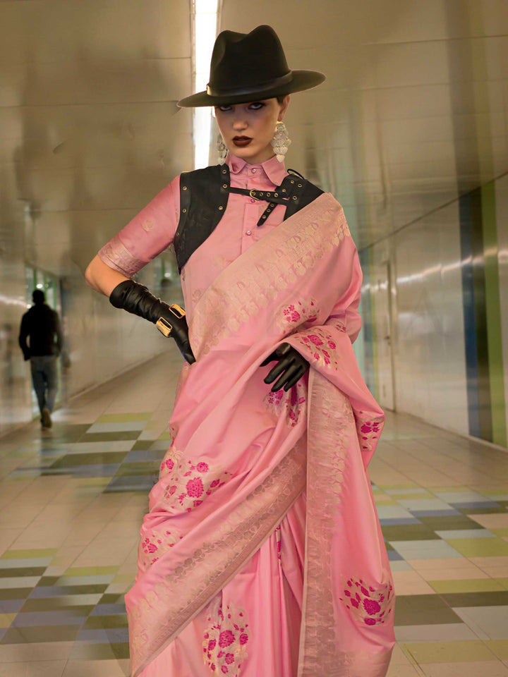 Pastel Pink silk saree with Champagne Zari zari and Magenta floral motifs, styled with contrast blouse, handloom weaving, festive-ready look with cinematic silhouette and bold accessories — ideal for events and grand celebrations. This image captures the side angle view showcasing blouse styling and zari border detail, ideal for visualizing festive elegance, designer appeal, and modern styling inspiration. Perfect for online shoppers seeking detailed previews before purchase, enhancing saree visual merchand