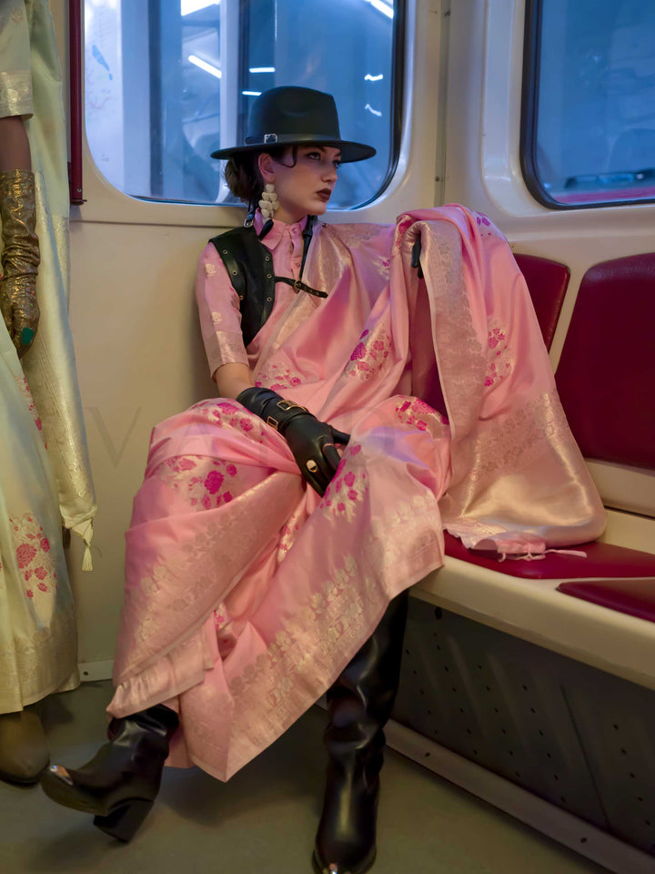 Pastel Pink silk saree with Champagne Zari zari and Magenta floral motifs, styled with contrast blouse, handloom weaving, festive-ready look with cinematic silhouette and bold accessories — ideal for events and grand celebrations. This image captures the model styling perspective with complete saree ensemble displayed, ideal for visualizing festive elegance, designer appeal, and modern styling inspiration. Perfect for online shoppers seeking detailed previews before purchase, enhancing saree visual merchand
