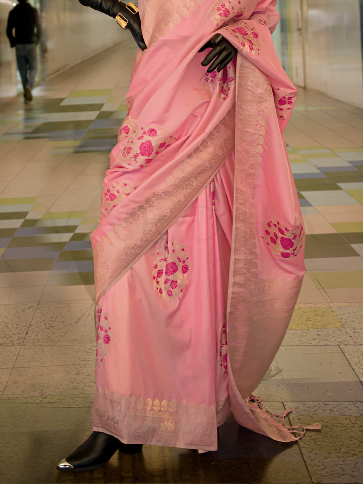 Pastel Pink silk saree with Champagne Zari zari and Magenta floral motifs, styled with contrast blouse, handloom weaving, festive-ready look with cinematic silhouette and bold accessories — ideal for events and grand celebrations. This image captures the back drape focus revealing pallu finesse and motif richness, ideal for visualizing festive elegance, designer appeal, and modern styling inspiration. Perfect for online shoppers seeking detailed previews before purchase, enhancing saree visual merchandising