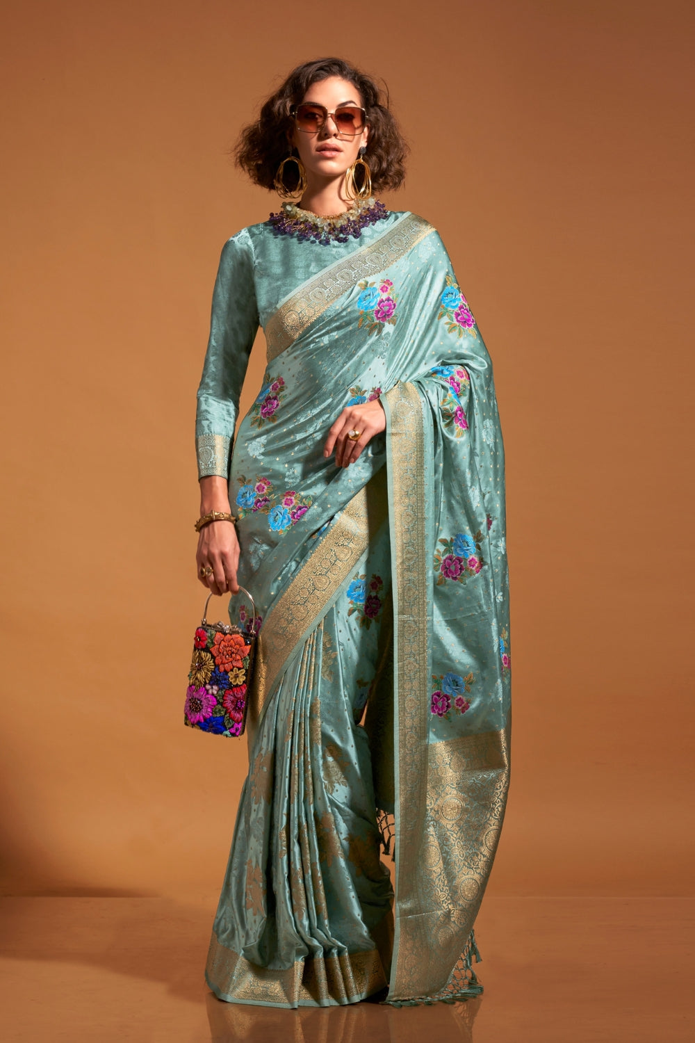 Mint Blue pure satin silk saree with multicolour floral handloom weaving and rich zari border. Styled for festive season and perfect for raksha bandhan, blending regal silk elegance with festive florals. This image captures the zoomed texture view illustrating fabric weave and print clarity, ideal for visualizing festive elegance, designer appeal, and modern styling inspiration. Perfect for online shoppers seeking detailed previews before purchase, enhancing saree visual merchandising and SEO-rich product d