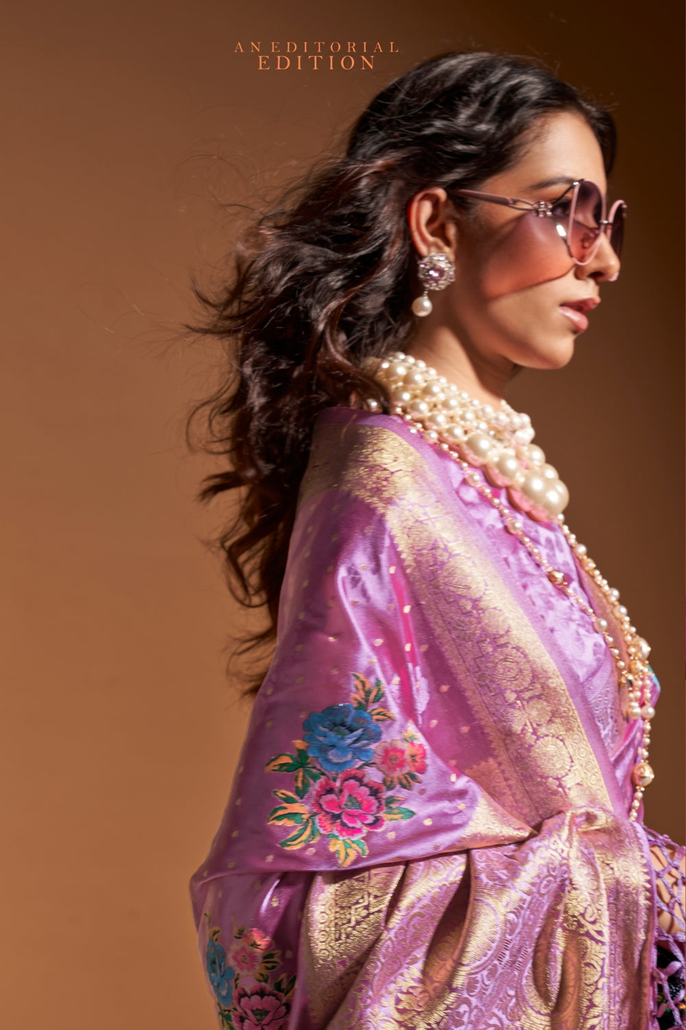 Lavender pure satin silk saree with multicolour floral handloom weaving and rich zari border. Styled for party-wear and perfect for bridal brunch, blending regal silk elegance with festive florals. This image captures the back drape focus revealing pallu finesse and motif richness, ideal for visualizing festive elegance, designer appeal, and modern styling inspiration. Perfect for online shoppers seeking detailed previews before purchase, enhancing saree visual merchandising and SEO-rich product display str