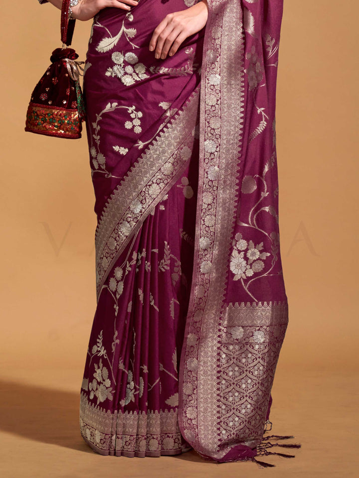 This festive saree is paired with a designer embroidered blouse featuring shimmering threadwork on the sleeves and neckline