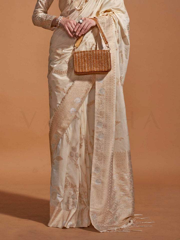 This festive saree is paired with a designer embroidered blouse featuring shimmering threadwork on the sleeves and neckline