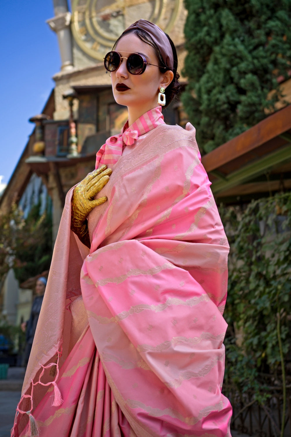 Peach and Rosy Pink Kimbus saree in rangkaat katan silk, designed with wave-striped motifs and a dramatic tassel pallu. Best styled for festive season and fashion-forward wedding morning celebrations. This image captures the front drape view highlighting pallu fall and pleats alignment, ideal for visualizing festive elegance, designer appeal, and modern styling inspiration. Perfect for online shoppers seeking detailed previews before purchase, enhancing saree visual merchandising and SEO-rich product displa