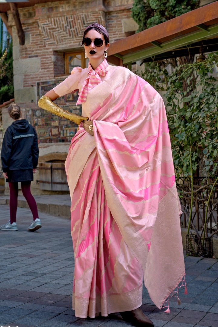Peach and Rosy Pink Kimbus saree in rangkaat katan silk, designed with wave-striped motifs and a dramatic tassel pallu. Best styled for festive season and fashion-forward wedding morning celebrations. This image captures the zoomed texture view illustrating fabric weave and print clarity, ideal for visualizing festive elegance, designer appeal, and modern styling inspiration. Perfect for online shoppers seeking detailed previews before purchase, enhancing saree visual merchandising and SEO-rich product disp